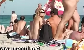 Naomi1 handjob a young guy on a public beach