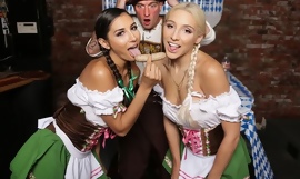 Two pigtailed hotties pleasuring bald-headed guy at Oktoberfest